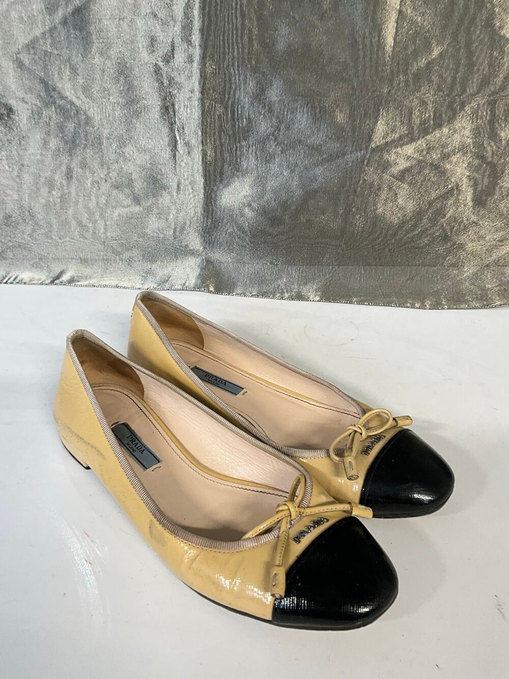 PRADA Beige Black Leather Ballet Flats Cap Toe Bow Accent Slip-On